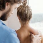 Eine Frau erhält eine Osteopressur an der Schulter in Anlehnung nach Liebscher und Bracht